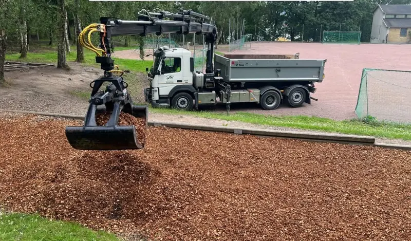 Kranbil utför markarbete på en yta